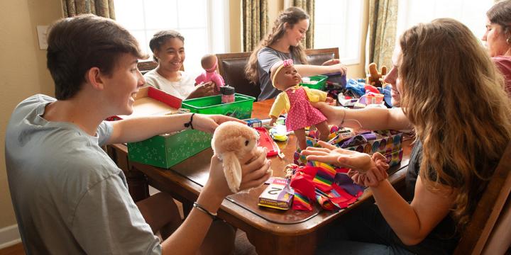 Friends and volunteers packing Operation Christmas Child shoeboxes together